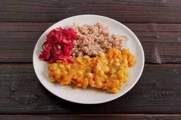 Stewed carrots with chickpeas and buckwheat on a table