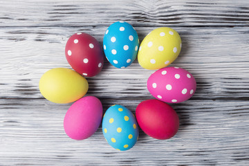Fototapeta na wymiar Multicolored Easter eggs over aged wooden background.