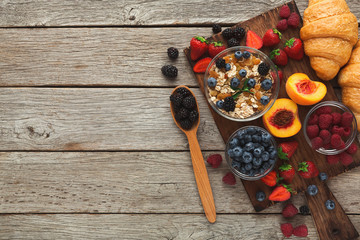 Tasty pastry, fruits and berries on rustic wood, top view