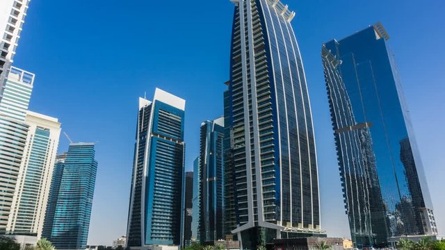 Sunny day, residential buildings in Jumeirah Lake Towers, time lapse, Dubai, UAE.