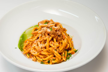 Delicious homemade pasta in a plate with parmesan and rosemary