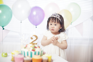 Obraz na płótnie Canvas Baby girl celebrate her second birthday