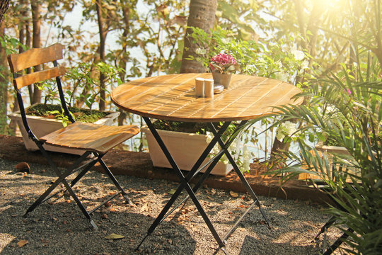 Summer Cafe. Wooden Round Table And Chair In The Sun. The Cozy Interior Of The Cafe. Wooden Interior