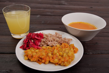 Stewed carrots with chickpeas and buckwheat on a table