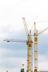 Fototapeta na wymiar Building crane under construction against blue sky