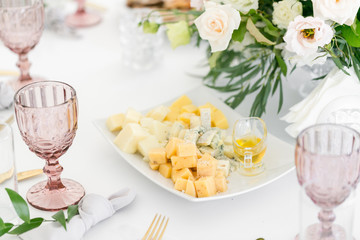 Obraz na płótnie Canvas Cheese platter. Plate with food on the table, snacks at the banquet, wedding banquet, table setting, dinner food, gala dinner.