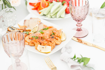 Fish platter. Plate with seafood on the table, snacks at the banquet, wedding banquet, table setting, dinner food, gala dinner.