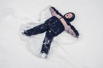 Fototapeta na wymiar boy lies on north pole snow
