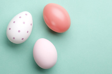 Three pastel easter eggs with copy space