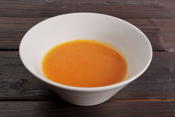 Pumpkin soup with tomatoes on a table
