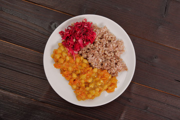 Stewed carrots with chickpeas and buckwheat on a table