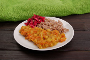 Stewed carrots with chickpeas and buckwheat on a table