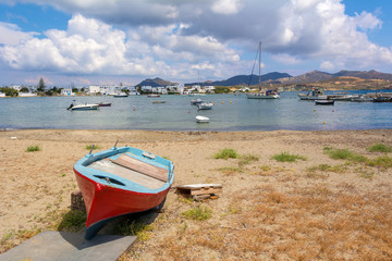 Fototapeta na wymiar Boat on beach in Pollonia village. Milos island, Greece.