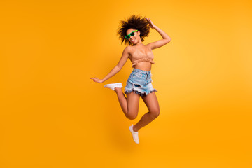 Whoo! I go crazy! Dreams come true! Full-length full-size photo of cheerful cute relaxed full of energy positive afro woman with curly short brown hair casual clothed, isolated on yellow background - obrazy, fototapety, plakaty