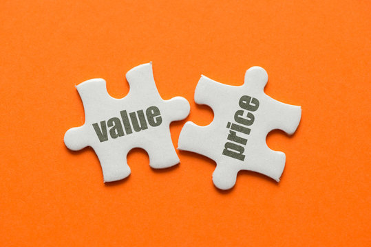 The Word Value Price On Two Matching Puzzle On Orange Background