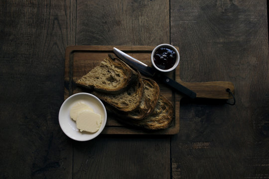Close-up of breakfast served on cutting board over wooden table