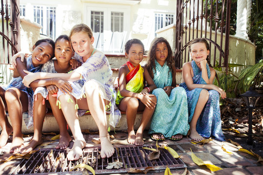 Portrait of friends sitting on step