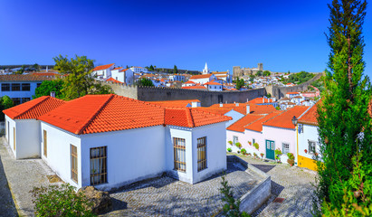 Obraz premium Panoramic view of the beautiful medieval historic center village of Obidos and Castle of Obidos. Wonderful romantic afternoon landscape at sunny weather. District of Leiria, in the centre of Portugal.