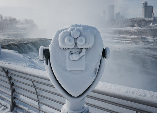 Frozen coin-operated binoculars by waterfall