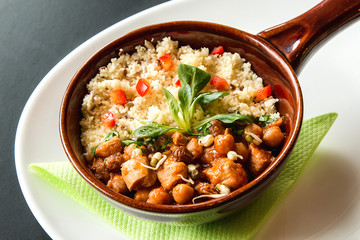 Close up of a Tajine, Morocco meal on a black table and white plate