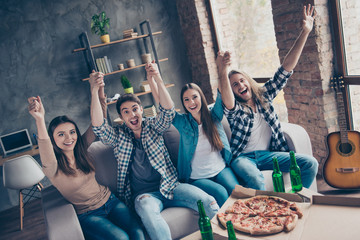 Yes, yeah, hooray! We are strong together! Concept of spending time together, supporting favorite team! Showing making wave using hands sitting on couch at home