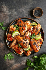 Grilled teriyaki chicken wings with black sesame and lime.Top view. © lilechka75