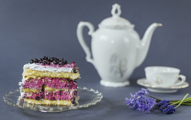 Piece of blueberry cake with hyacinth and cup of tea