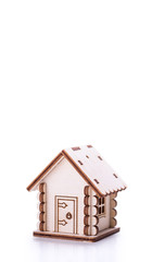Wooden model of house on white background