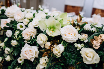 close-up of a composition of roses, eustoma of white color, fir, pistachio