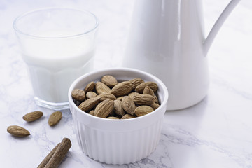 Organic homemade almond milk on light background.