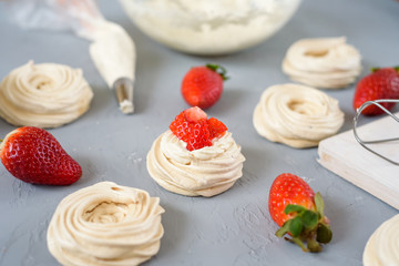 Meringues Pavlova cakes with strawberry. Flat lay, top view