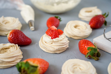 Meringues Pavlova cakes with strawberry. Flat lay, top view