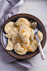 Plate of pierogi or varenyky, vareniki, Dumplings, filled with potato. Pyrohy - dumplings with filling. View from above, top, overhead