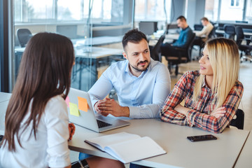 Managers smiling while interviewing female candidate