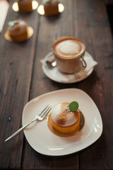 Breakfast in the cafe, a small pancake and coffee on the wooden table