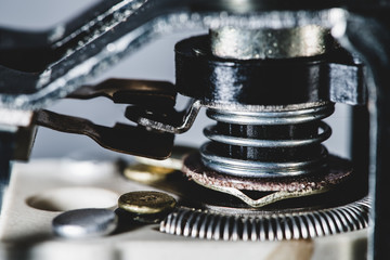 Detailed background image from auto part. Automotive mechanism with spring close-up.