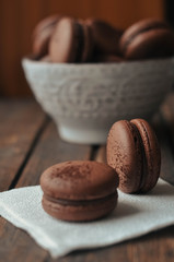 Brown Macarooni lie on a napkin and a wooden table