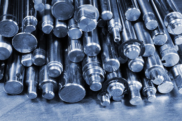 Shiny metal round bars and rods on steel background
