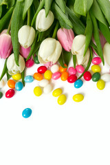tulips and Easter candies isolated on white