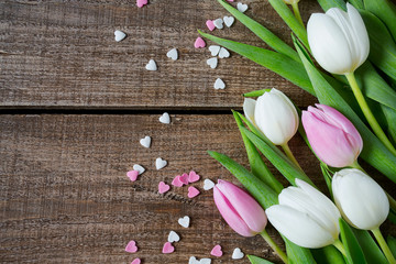 tulips and hearts on wooden surface