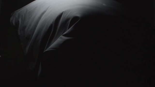 Black Cloth Floating down on a stark backdrop. Abstract footage of black cloth floating down.