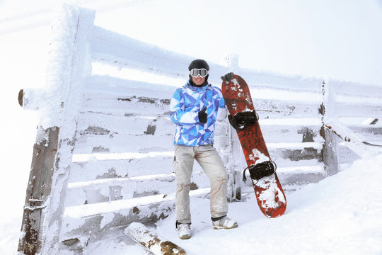 Snowboarder at snowy resort. Winter vacation