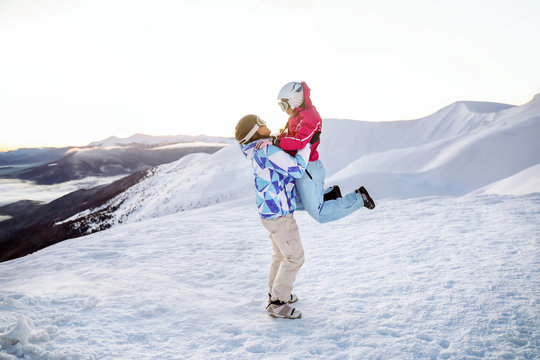 Happy couple having fun at snowy ski resort. Winter vacation