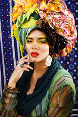 beauty bright woman with creative make up, many shawls on head l