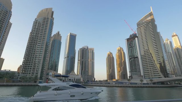 White yacht sailing in Dubai Marina