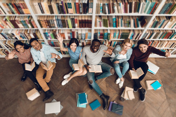 Top view group of ethnic multicultural students in library.
