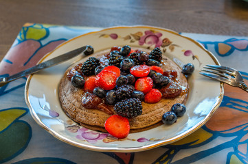 Pancakes for breakfast with berries and jam