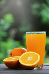 Orange juice and oranges, selective focus.