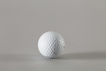 Golfball solo auf grauem Hintergrund
