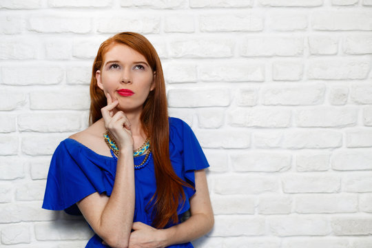 Facial Expressions Of Young Redhead Woman On Brick Wall